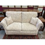 Pair of good quality traditional sofas, cream upholstered and raised on square tapered legs and cast