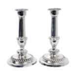 Pair of George III silver candlesticks with plain columns, removable sconces and egg and dart border