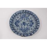 An 18th century Dutch Delft dish, with unusual leaf moulded border