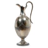 Victorian silver ewer of fluted baluster form, with hinged cover and loop handle