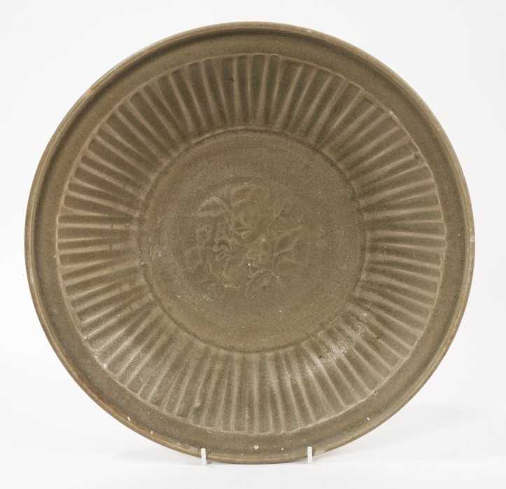 Chinese celadon dish, Yuan dynasty, from the Java shipwreck, with ribbed moulding and central floral