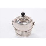 Edwardian silver tea caddy of oval form, with twin ring handles, fluted decoration and hinged domed