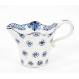 A Derby blue and white jug, circa 1770, bucket shaped with unusual lozenge moulding, painted with fl