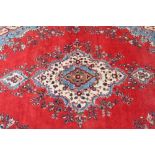 Large Persian carpet on red ground