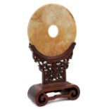Antique Chinese jade bi-disc on carved wood stand