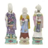 Three Chinese porcelain figures of immortals, Qianlong period, each polychrome decorated and shown s