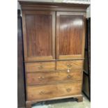 19th century mahogany linen press with Greek key carved cornice above twin panelled doors enclosing