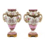 A small pair of Sèvres ormolu-mounted porcelain urns, 19th century, decorated with floral sprays and