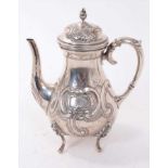 19th century continental silver coffee pot of baluster form with embossed floral and scroll decorati