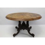 Victorian figured burr walnut veneered and marquetry inlaid oval table with tilt top on carved walnu