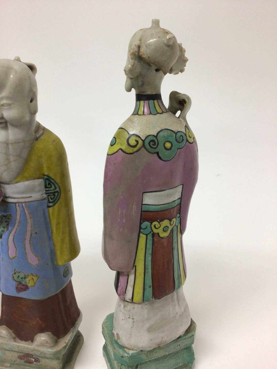 Three Chinese porcelain figures of immortals, Qianlong period, each polychrome decorated and shown s - Image 6 of 9