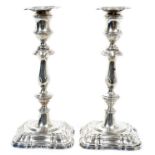 Pair George V silver candlesticks in the Georgian style, with decorative baluster stems