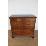 George III mahogany chest of drawers with canted angles and ogee bracket feet.