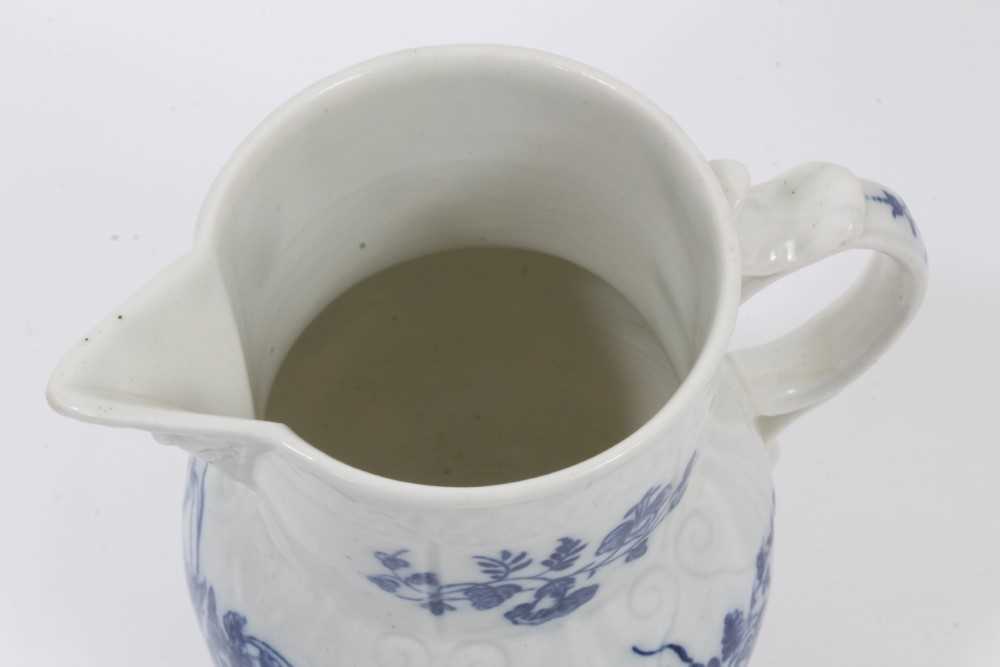 A Caughley blue and white cabbage leaf moulded jug with mask spout, decorated with bouquets of flowe - Image 4 of 5