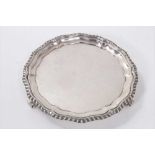 1920s silver waiter of circular form, with piecrust and gadrooned border, on three scroll feet