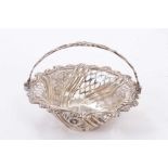 George III silver sweet meat basket of circular form with pierced decoration and central swing handl