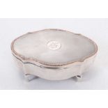 George V silver jewellery box of shaped oval form with engine turned decoration, engraved date to ce