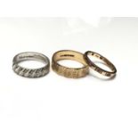 9ct white gold wedding ring, 9ct yellow gold wedding ring and 9ct gold eternity ring