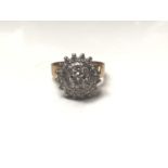 Diamond cluster ring with twenty five brilliant cut diamonds in tiered claw setting on shank stamped