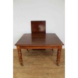 Victorian mahogany extending dining table with one extra leaf on turned legs and brass capped castor