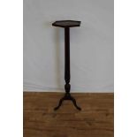 Late Victorian mahogany torchere with hexagonal top on reeded column and three hipped splayed legs,