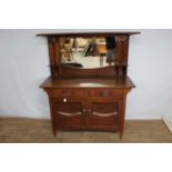Edwardian oak two height sideboard with raised mirror back, two drawers and two panelled doors below