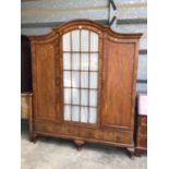 Good quality early 20th century walnut dome top triple wardrobe with central glazed door flanked by