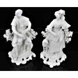 A pair of Derby bisque figures of a shepherd and shepherdess, shown seated on scrolled rococo bases,