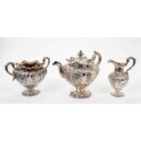 Early Victorian Scottish silver three piece tea set of melon form with repoussé floral decoration
