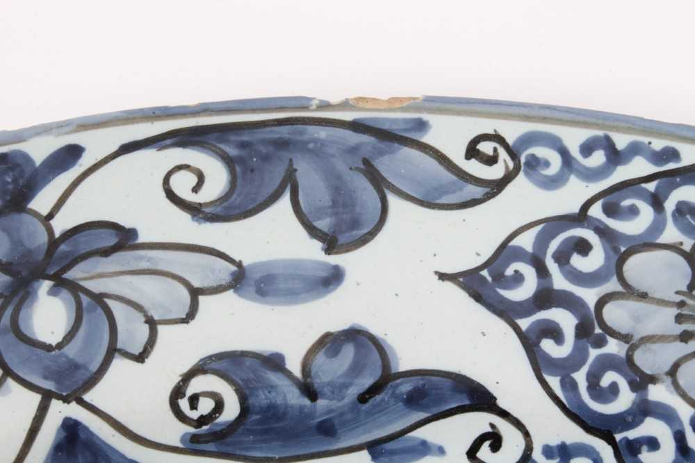 A blue and white Dutch delftware dish, circa 1700, painted in the Oriental style with birds amongst - Image 6 of 9