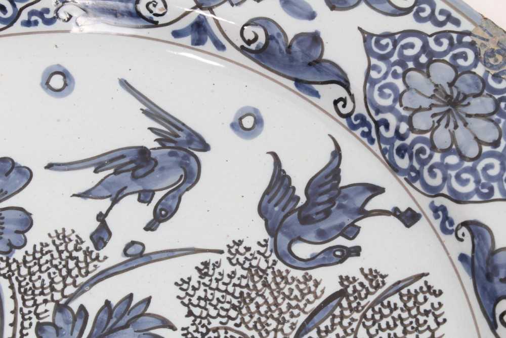 A blue and white Dutch delftware dish, circa 1700, painted in the Oriental style with birds amongst - Image 3 of 9