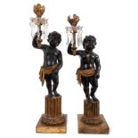 Pair of early 19th century candlesticks with putto supports and prismatic drops.