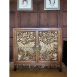 Chinese carved hardwood and parcel gilt cabinet, the twin doors decorated with phoenixes, carved fri