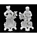 A pair of Derby bisque figures of a boy and a girl, late 18th/early 19th century, shown seated on sc