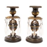 Pair of Regency bronze and ormolu dwarf candlesticks with prismatic drops