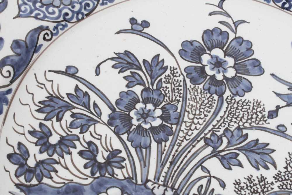 A blue and white Dutch delftware dish, circa 1700, painted in the Oriental style with birds amongst - Image 2 of 9