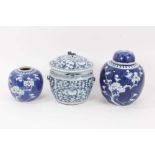 A 19th century Chinese blue and white bowl and cover, together with two prunus jars, circa 1900 (one
