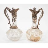 Near pair Victorian Cut glass claret jugs of onion form, with silver mounts.