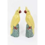 Pair of Chinese porcelain yellow cockatoo perched on leafy mounted bases