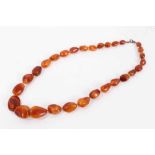 Old amber necklace with a string of graduated free form butterscotch amber beads, 60cm, approximatel