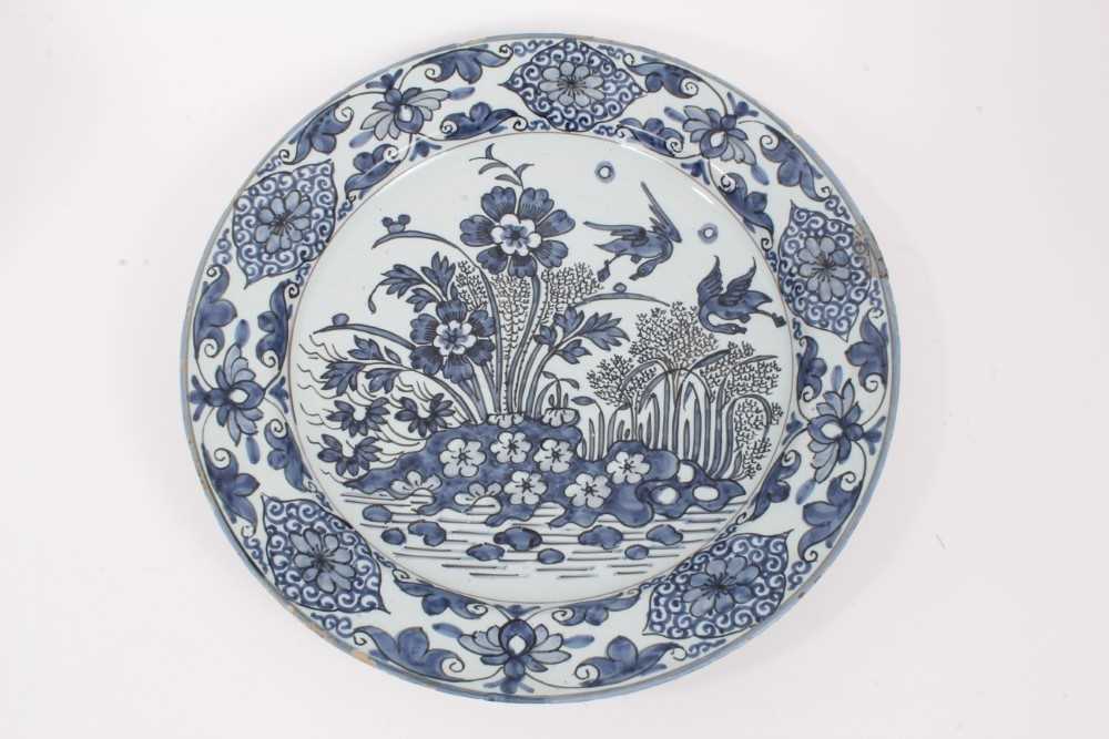 A blue and white Dutch delftware dish, circa 1700, painted in the Oriental style with birds amongst