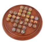 Collection of 32 Victorian multi-twist glass marbles on solitaire board