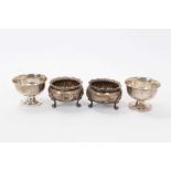 Pair of Victorian silver salt cellars of cauldron form with gadrooned borders, raised on three scrol