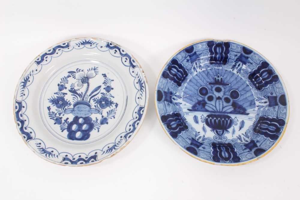 Two 18th century blue and white Dutch delftware dishes, one painted with the Peacock pattern, the ot