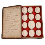 Good collection of 19th century Grand Tour plaster intaglios in case and in a book.