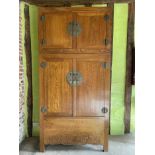 Large Chinese elm sectional cupboard with internal drawers and shelves enclosed by four doors, 125cm