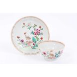 Chinese famille rose export porcelain tea bowl and saucer, painted with an exotic bird in a fenced g