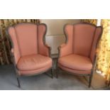 Pair of French-style easy chairs with carved and painted frames, pink upholstery, on fluted tapered