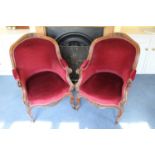 Pair of Victorian mahogany framed armchairs with carved scroll show frames, red velvet upholstery, o