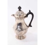 Late Victorian silver hot water pot with floral scrollwork decoration (London 1896) 23cm high